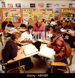Education - A junior high school teacher works in the classroom with students in a group learning setting / California, USA. Stock Photo