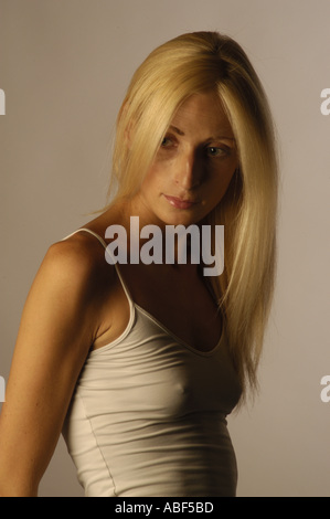 Front view of slim blonde woman with her arms akimbo as full body