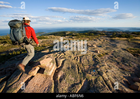 A hiker on Cadillac Mountain in Maine s Acadia National Park South Ridge Trail Stock Photo