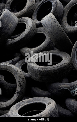 A pile of abandoned motor car tyres (tires) are left on wasteland in Stratford, future location of the 2012 Olympics, London UK. Stock Photo