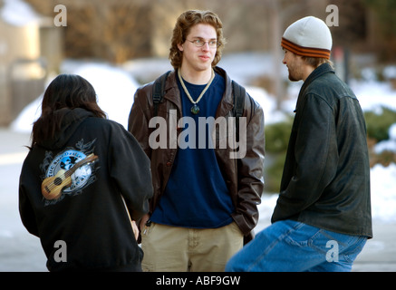 Three university students talk outside on the University of Nebraska campus in Lincoln. Stock Photo