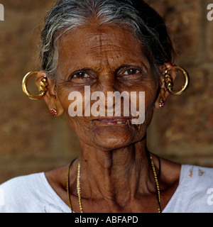 An old Kerala lady with traditional Christian costume and ear rings called mekkamothiram smiling at the Camera Stock Photo