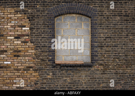 Breeze blocks have sealed up this window at Marshgate industrial estate, location for the 2012 Olympic village, Stratford London Stock Photo