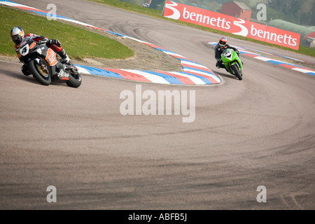 Two racing motorbikes superbikes leaning through a chicane Stock Photo