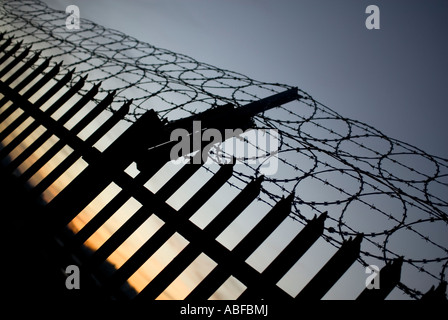 security fencing around business premises to keep thieves out These are abstract views of the precautions businesses have to Stock Photo