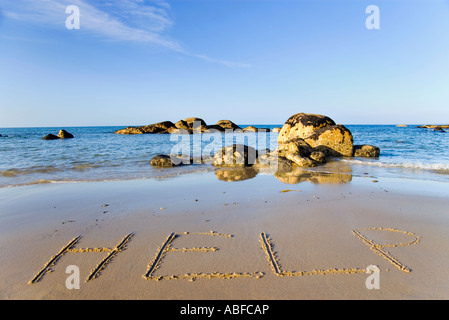 HELP written in sand on beach Stock Photo