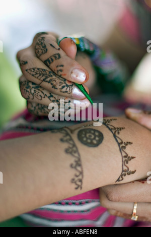 Applying decorative henna Stock Photo