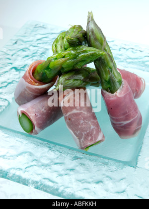 A plate of asparagus spears wrapped in parma ham canapes Stock Photo