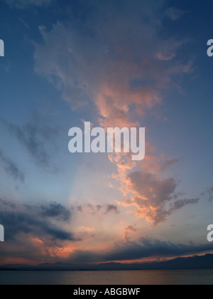 Beautiful cloud formation at sunset over Garda Lake Italy vertical Stock Photo