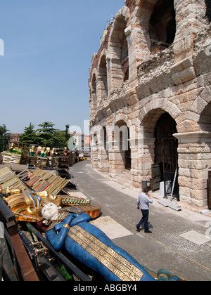 Aida decor parts in front of the famous Roman arena amphitheatre with man talking on his  cellphone in Verona Veneto Italy Stock Photo