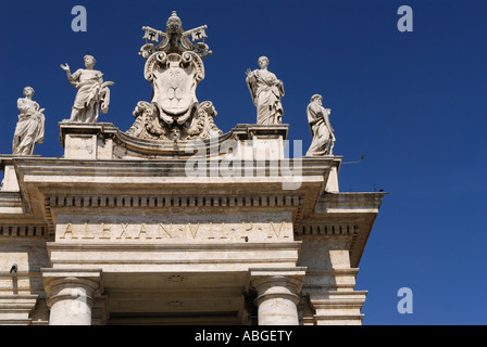 Detail of Statues and Vatican coat of arms on St Peters Papal Basilica piazza colonnades Rome Italy with blue sky Stock Photo