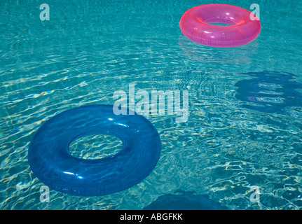 Inflatable rings in a swimming pool Stock Photo