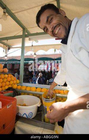 Seller makes orange juice at stand Place Djemaa El Fna Marrakech Morocco Stock Photo
