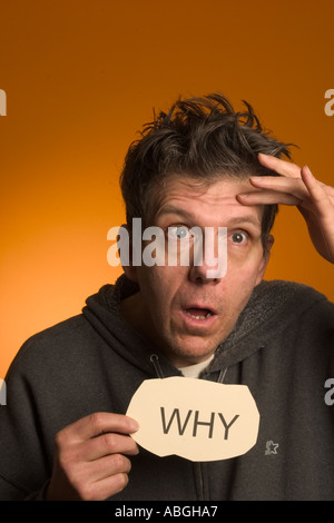 Scary looking man holding a sign reading "Why Stock Photo