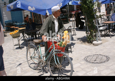 Man on bicycle carrying  his shopping Houmt Souk Djerba Stock Photo
