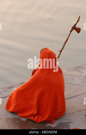 Sadhu sits on the banks of the Ganges during the sunrise Stock Photo