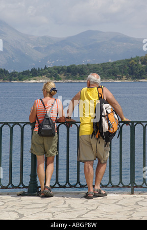 Corfu Old Town couple admiring the view from the promenade near the Old Fort Stock Photo