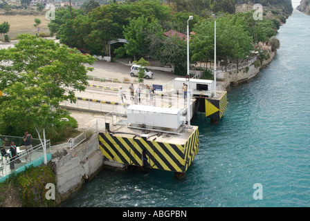 Corinth Canal waterway submersible road bridge designed to be lowered into canal to allow shipping to pass over spectators watching cruise ship Greece Stock Photo