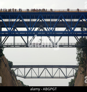 Greek Corinth Canal spectators on road bridge watching cruise ship below from where this image was taken Isthmia Peloponnese Greece Europe Stock Photo