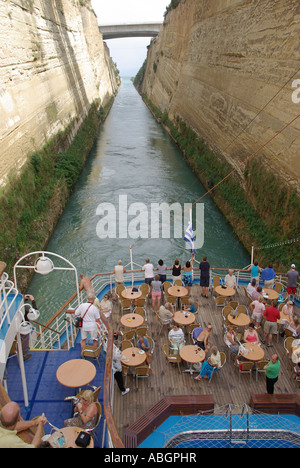 Tight squeeze for cruise ship passing through narrow Corinth Canal passengers on stern leisure deck Stock Photo