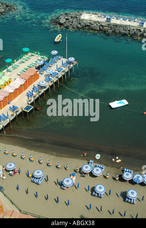 Sorrento coastal resort aerial view looking down on waterside beach sunbathing facilities early arrivals enjoying morning sunshine Stock Photo