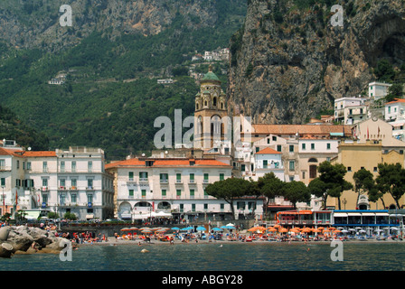 Amalfi Coastline view from sea town waterfront sandy beach medieval Roman Catholic cathedral mountain rock face backdrop Salerno Campania Italy Europe Stock Photo