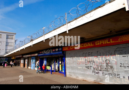 Run down shopping centre with razor wire on Gurnos Estate Merthyr Tydfil South Wales UK Stock Photo