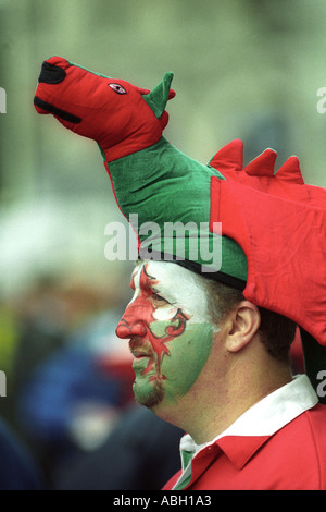 Welsh rugby fan wearing red dragon hat and painted face at Wales international match Millennium Stadium Cardiff South Wales UK Stock Photo