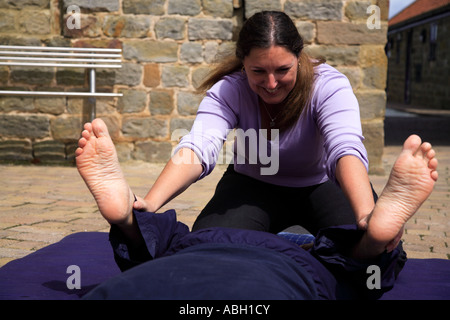 Wide quad stretch as part of a Thai body massage Stock Photo