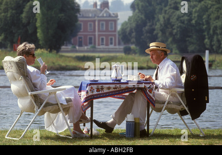 Picnic UK. Senior couple, picnicking on the river Thames at Henley summer music festival 1990s England Circa 1995 HOMER SYKES Stock Photo