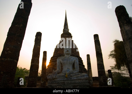 Buddha statue and chedi Wat Sa Si sunset Sukothai historic temples park Thailand Stock Photo