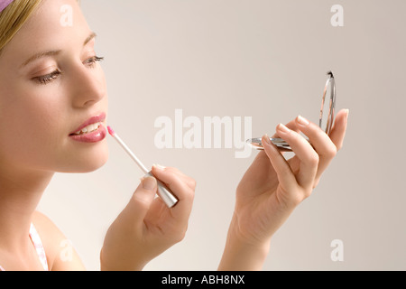 Portrait of a young woman smiling, looking at the camera, indoors (studio) Stock Photo