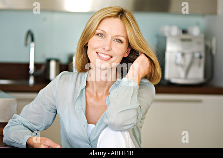 Smiling woman with hand in hair Stock Photo