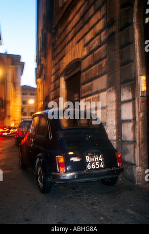 Fiat 500 bubble car parked in narrow street in rococo town Noto cobbled ...