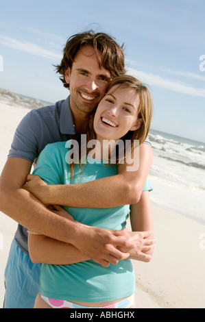 Couple in an embrace, on the beach, posing for the camera, outdoors Stock Photo