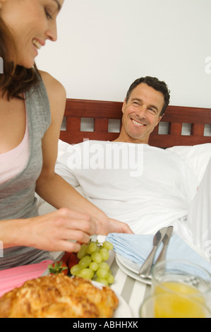 Couple having breakfast in bed Stock Photo