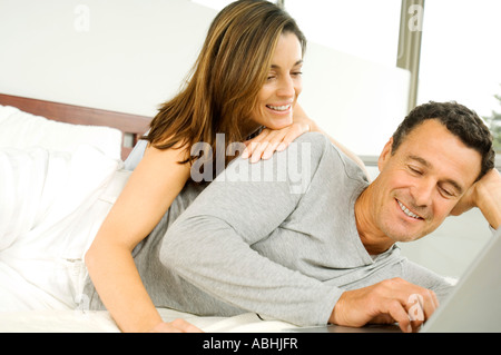 Couple in bed, using laptop Stock Photo
