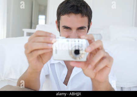 Young man using digital camera Stock Photo