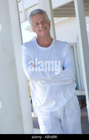 Man with arms crossed, smiling for the camera Stock Photo