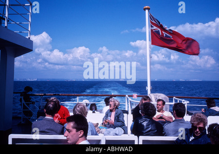 Group of people on a cross English Channel ferry leaving England with the white cliffs of Dover in the distance Stock Photo