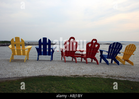 Two Adirondack chairs in a row at the edge of Long Lake ...