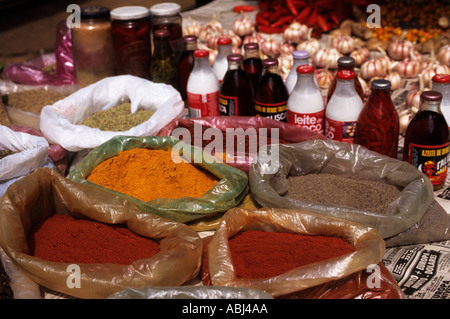 Sao Paulo, Brazil. Fresh spices (colorao, pimenta do reino, pimenta da malagueta), coconut milk, dende oil and peppers in oil. Stock Photo