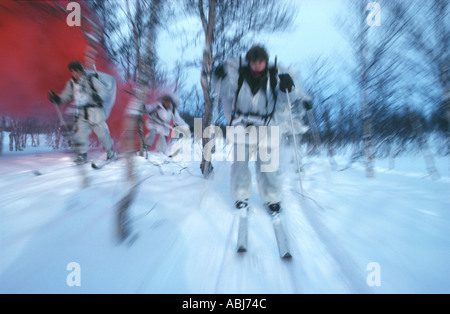 Mountain and Arctic Warfare with soldiers on skis in snow and ice Stock Photo