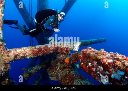 Scuba divers swimming in a rig in the Gulf of Mexico, off Texas Stock ...