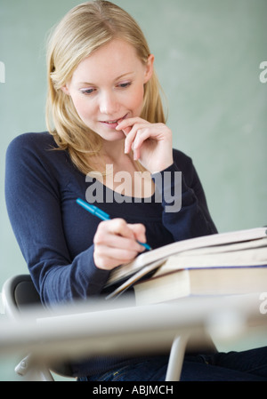 Woman writing in notebook Stock Photo