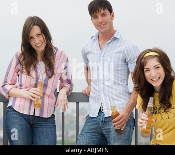 Friends drinking beer at party Stock Photo