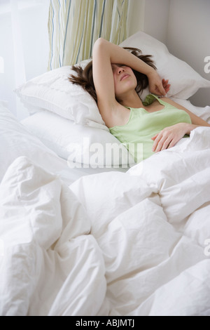 Woman laying in bed Stock Photo