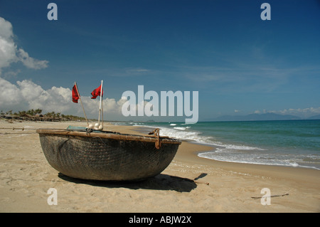 A traditional, round basket-style Vietnam fishing boat on Cua Dai Beach near Hoi An on the central Vietnamese coast. Stock Photo