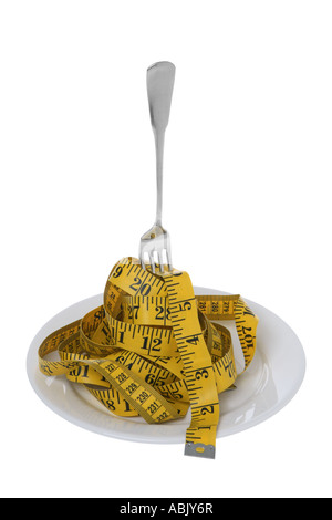 Tape measure with fork on plate cut out on white background Stock Photo
