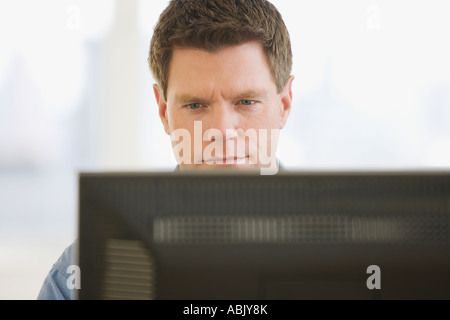 Man looking at computer screen Stock Photo